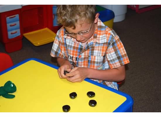 Child sorting small objects to improve fine motor coordination.