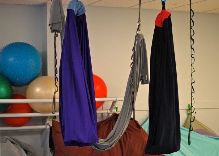 Colorful fabric swings used for physical therapy.