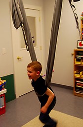 Child engaging in deep pressure exercise. 