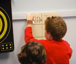 Children practicing handwriting tasks.