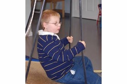 Child engaging in vestibular activity exercise.